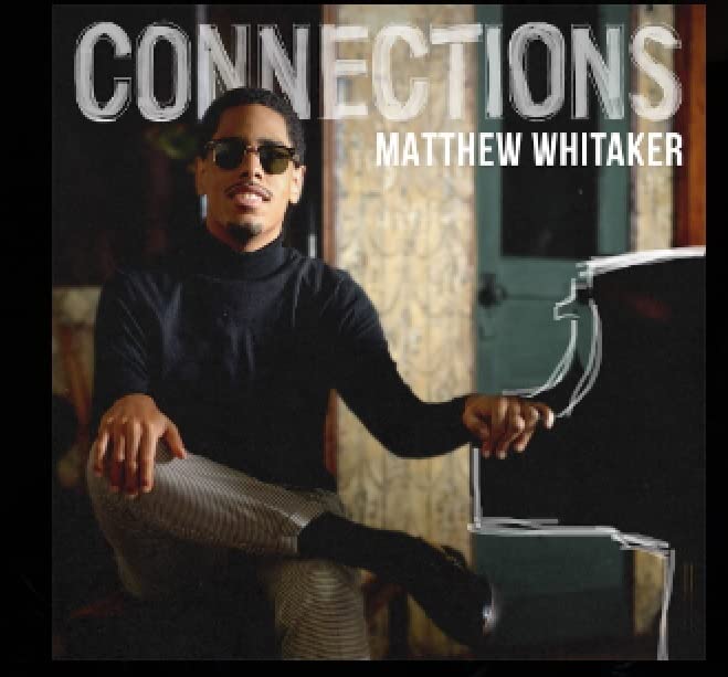 Album cover featuring Matthew Whitaker in sunglasses, seated at a piano.