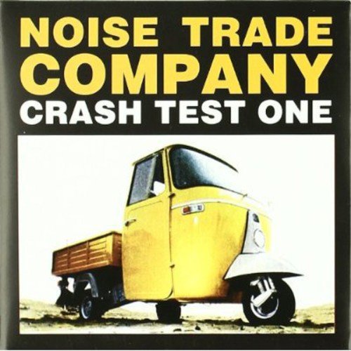 CD cover: yellow text, a yellow three-wheeled vehicle, black background.