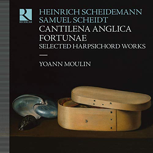 CD cover with text, a wooden box, and a shell on a table.