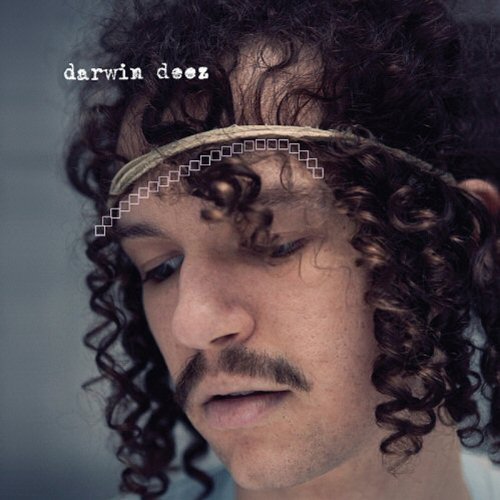 Darwin Deez album cover featuring a man with curly hair and a headband.