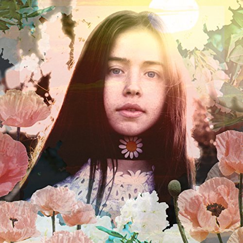 Flo Morrissey portrait surrounded by pink and white poppy flowers.
