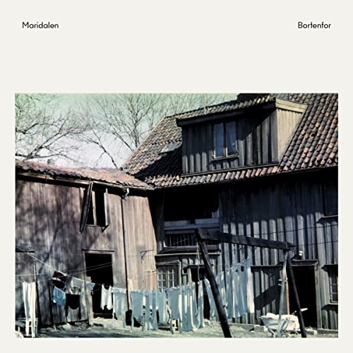 CD cover with a weathered wooden building and hanging laundry.