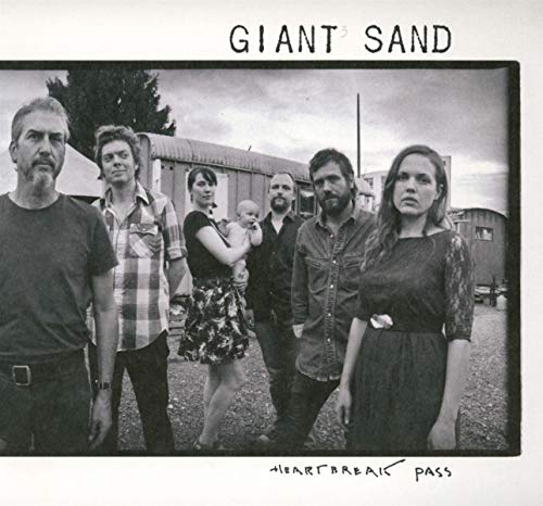 Black and white photo of six people standing in front of buildings.