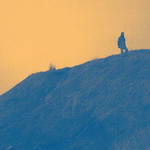 Silhouetted figure on a hill against a warm, textured orange and blue sky.