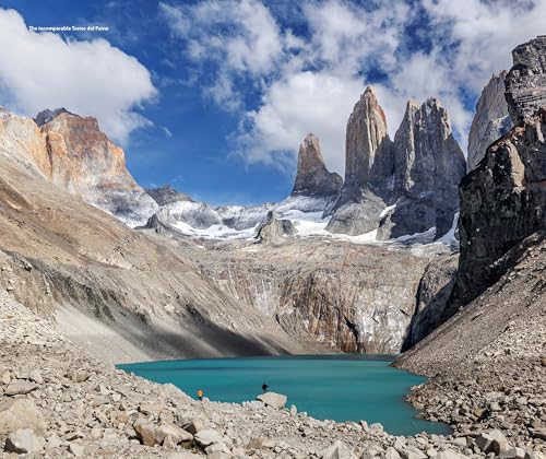 Torres del Paine mountains and turquoise lake with two hikers.