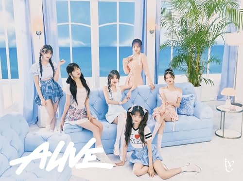 Six women posing on a blue sofa in a bright room.
