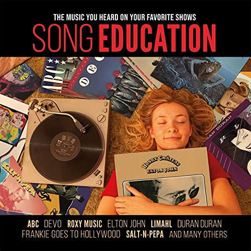 Record player with vinyl records and a person lying among them.