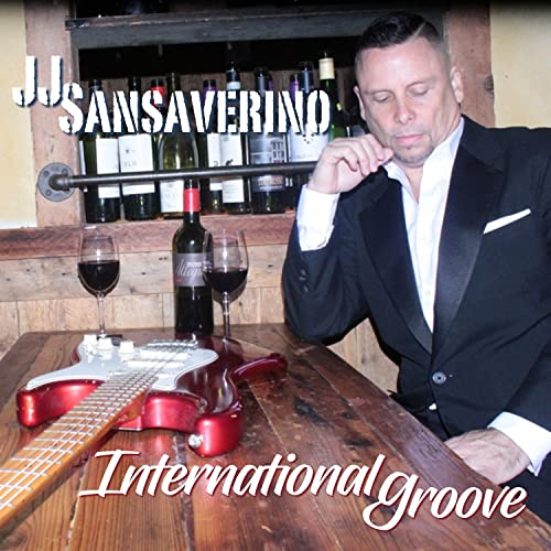 CD cover featuring a man in a tuxedo with a red electric guitar.