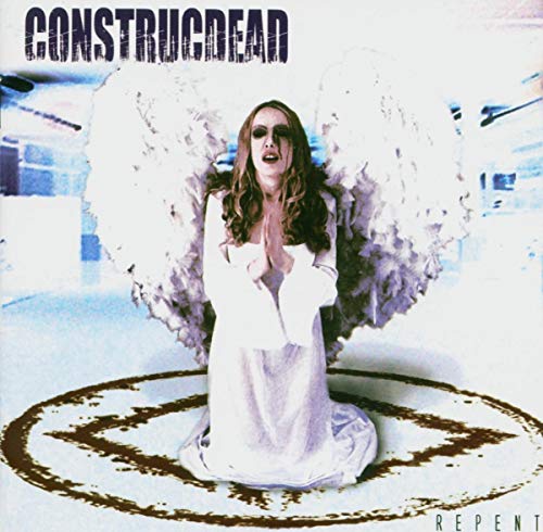 CD cover: woman with angel wings kneels in a dark circle.