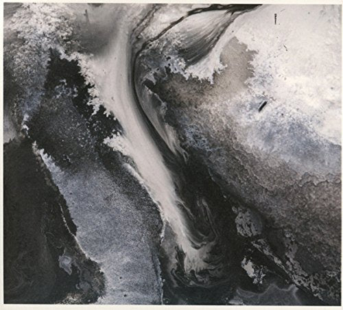 Abstract swirling grey and black paint resembling a landscape.