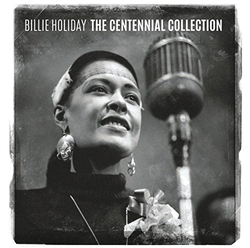 Black and white portrait of Billie Holiday singing into a vintage microphone.