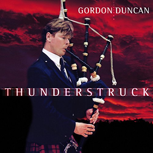 CD cover featuring a man playing bagpipes against a red sky.