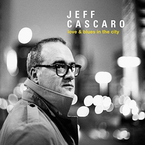 Black and white portrait of Jeff Cascaro wearing glasses and a jacket.