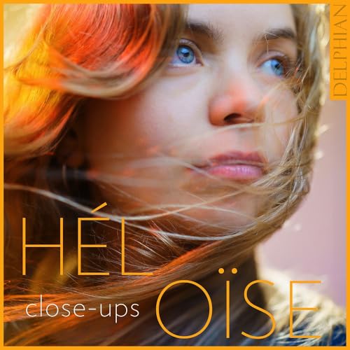 Close-up portrait of a woman with orange hair, album cover art.