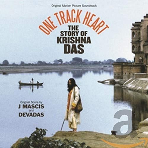 CD cover: Krishna Das by a river, with building reflections.