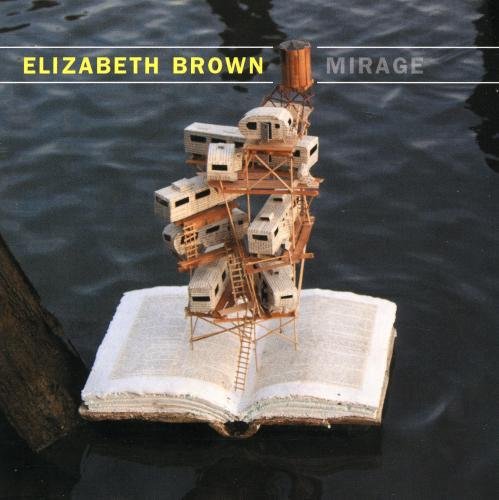 CD cover: miniature buildings on an open book, water background.