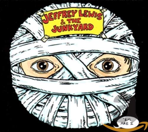CD cover: face wrapped in bandages, with large, expressive eyes.