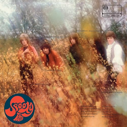 The band Spooky Tooth stands in a field of tall, golden autumn grass.