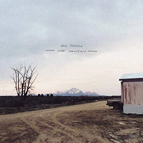Album cover: landscape with mountains, bare tree, and small building.