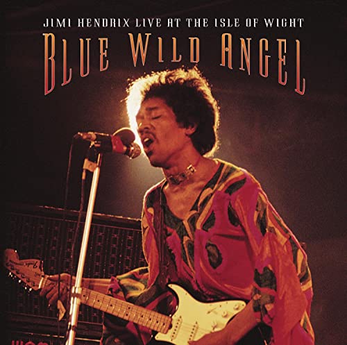 Jimi Hendrix performing with a guitar and microphone on stage.