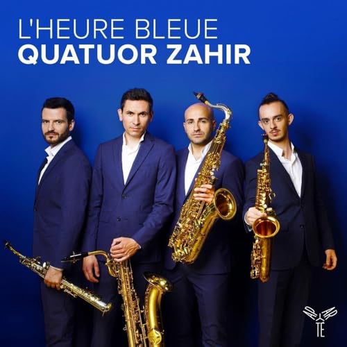 Four men in suits holding saxophones against a blue background.