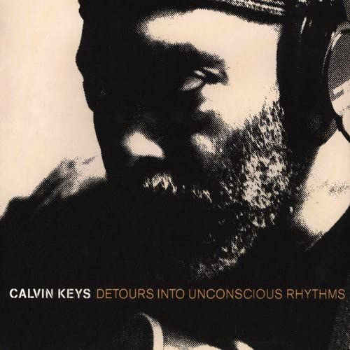 Black and white portrait of Calvin Keys with beard and headphones.