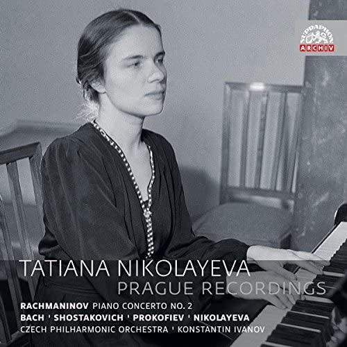 Black and white portrait of pianist Tatiana Nikolayeva with a piano.