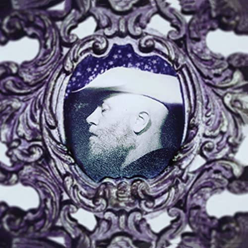 Vinyl record cover featuring a portrait of a bearded man in a frame.