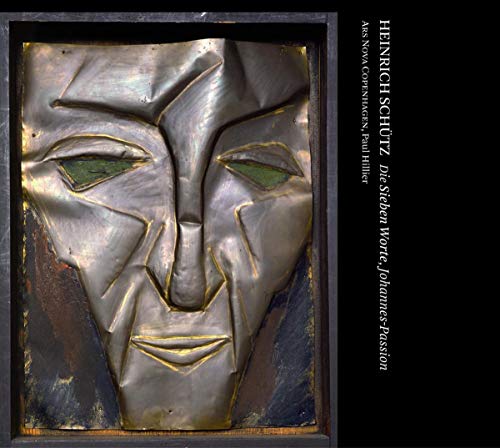 CD cover featuring a distressed, metallic face sculpture in dark tones.