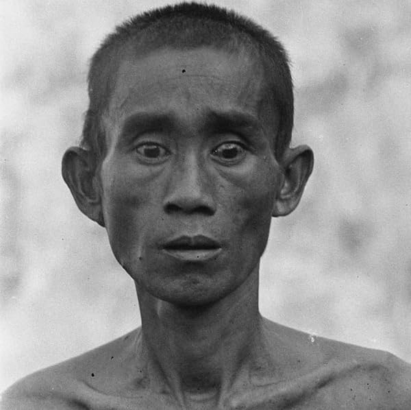 Black and white portrait of a man with a serious expression.