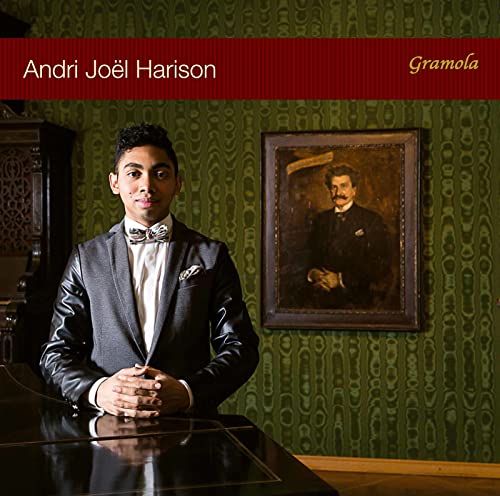 CD cover featuring a young man in a suit standing indoors.