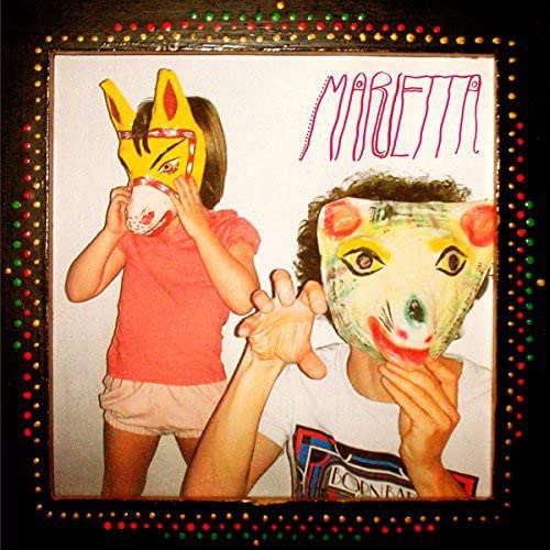 CD cover: two people wearing colorful, painted masks.