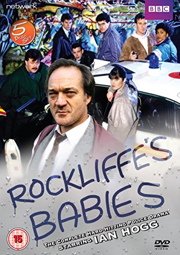 Cast members of Rockliffe's Babies posed in front of a police car and graffiti wall.