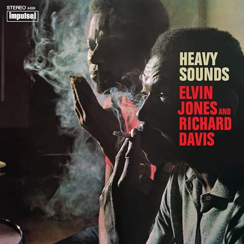 Album cover: two Black musicians smoking, text “Heavy Sounds” and artist names.