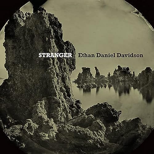 Vinyl record cover: rocky landscape with “Stranger” and artist’s name.