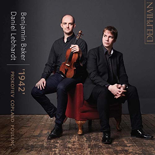 Two musicians with a violin, posing on chairs against a dark background.