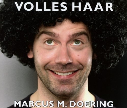 Marcus Doering with large, curly afro and smiling expression.