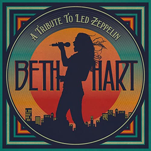 Silhouette of a singer with a microphone against a sunset and city skyline.