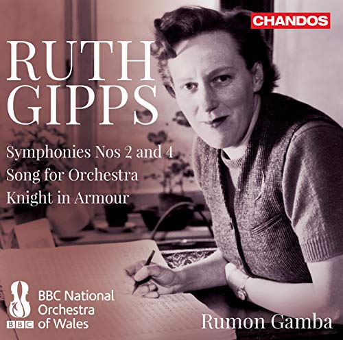 Black and white photo of Ruth Gipps writing music at a desk.