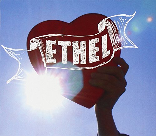 Red heart with "Ethel" text, held against a bright blue sky.