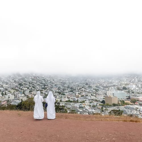 CD cover: Two figures in white robes overlooking a foggy cityscape.