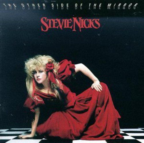 Stevie Nicks album cover, red dress, black and white checkered floor.