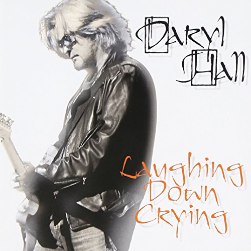 Daryl Hall in a leather jacket holding a guitar, album cover.
