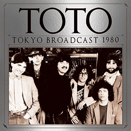 Toto album cover: band photo from 1980, silver textured background.
