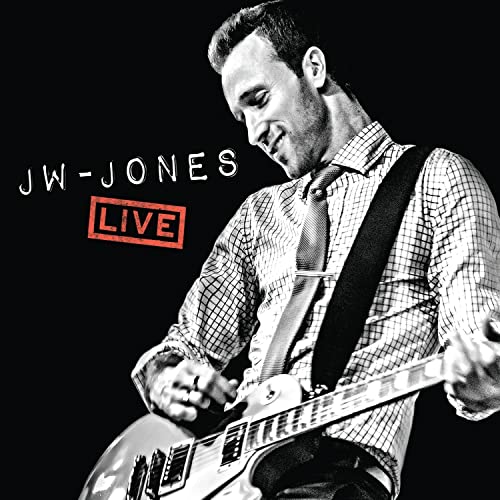 Black and white album cover featuring JW-Jones playing guitar live.