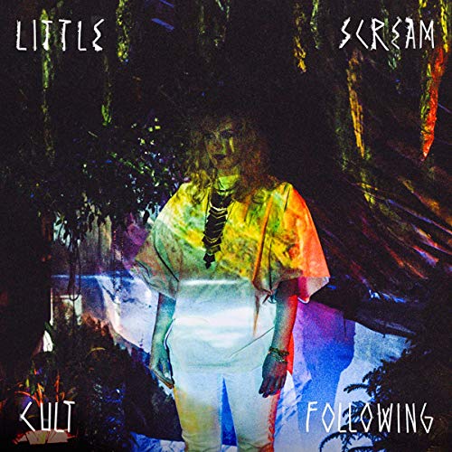 Album cover: person in tie-dye, surrounded by dark, blurred foliage.
