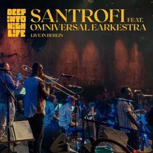 Santrofi band performing live on stage with brass instruments and microphones.