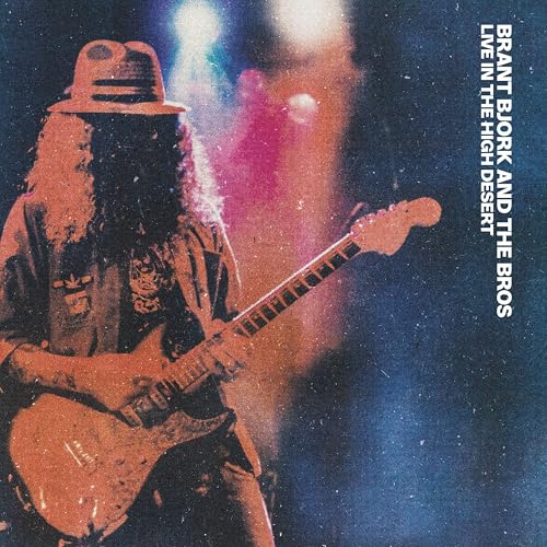 Musician with a guitar, wearing a hat, on album cover.