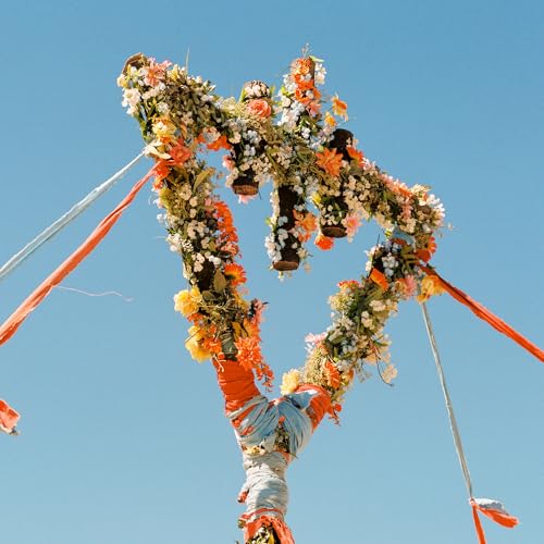 Floral arrangement shaped like the title “Flowers” against a blue sky.