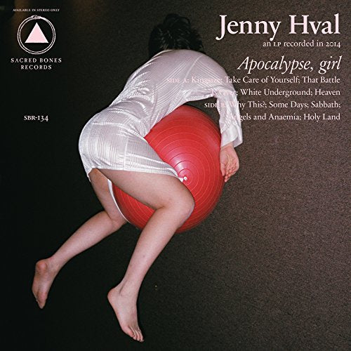 CD cover: woman in a dress balancing on a large red exercise ball.